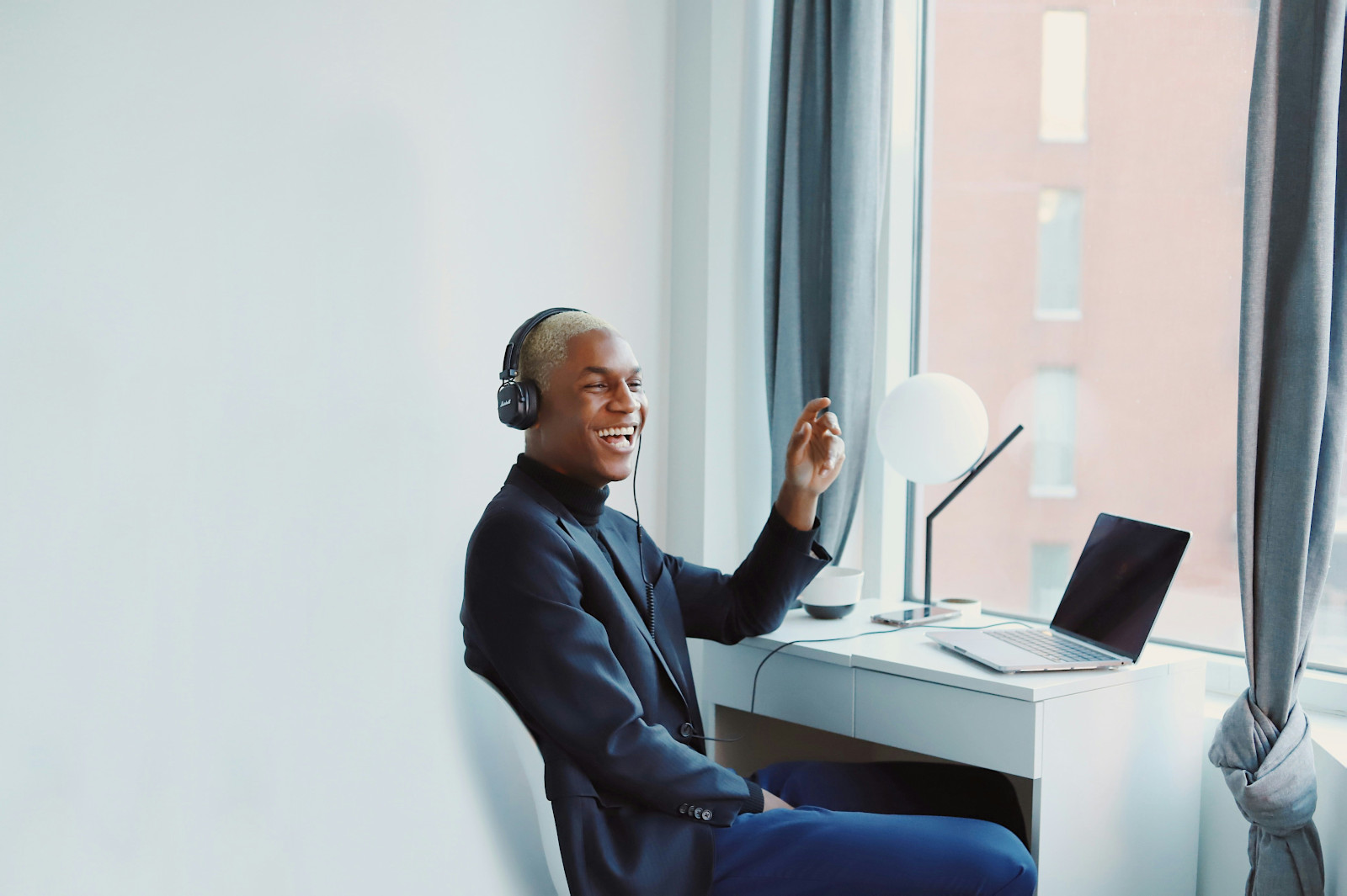 Administrative professional smiling in his home office